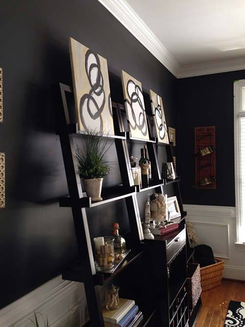 Leaning canvases on shelves